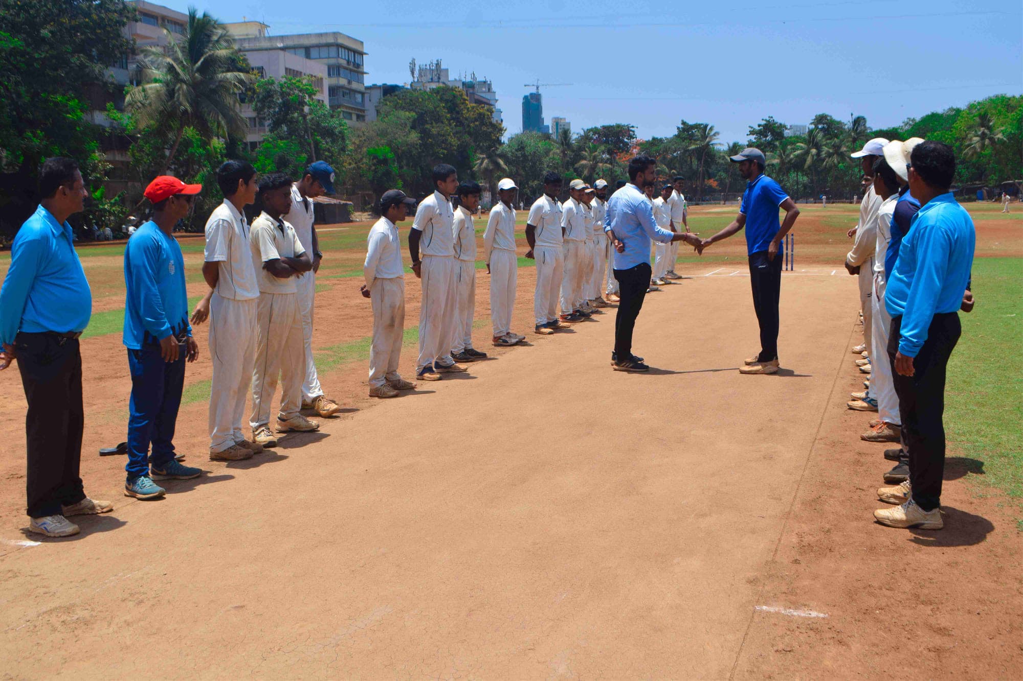 Players walking out across the pitch at Cross Maidan