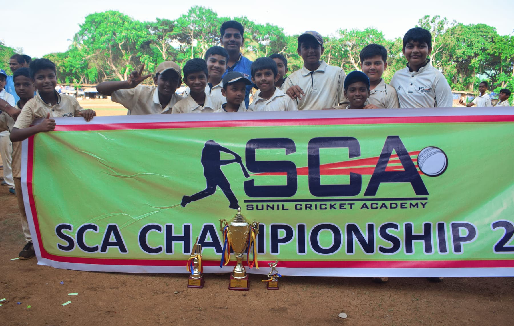 Junior players behind an SCA Championship banner with their trophies